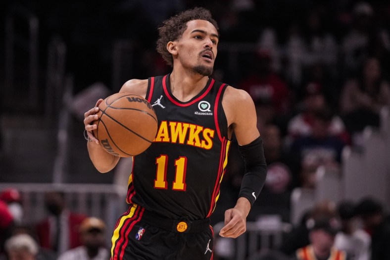 Mar 20, 2022; Atlanta, Georgia, USA; Atlanta Hawks guard Trae Young (11) brings the ball up the court against the New Orleans Pelicans during the first half at State Farm Arena. Mandatory Credit: Dale Zanine-USA TODAY Sports