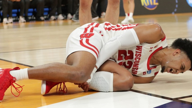 Wisconsin guard Chucky Hepburn (23) writhes in pain after being injured  during the first half in their second round game of the 2022 NCAA Men's Basketball Tournament against Iowa State Sunday, March 20, 2022 at Fiserv Forum in Milwaukee, Wis.

Mjs Uwmen21 1 Jpg Ncaa21