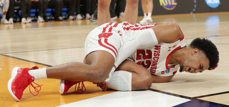Wisconsin guard Chucky Hepburn (23) writhes in pain after being injured  during the first half in their second round game of the 2022 NCAA Men's Basketball Tournament against Iowa State Sunday, March 20, 2022 at Fiserv Forum in Milwaukee, Wis.

Mjs Uwmen21 1 Jpg Ncaa21