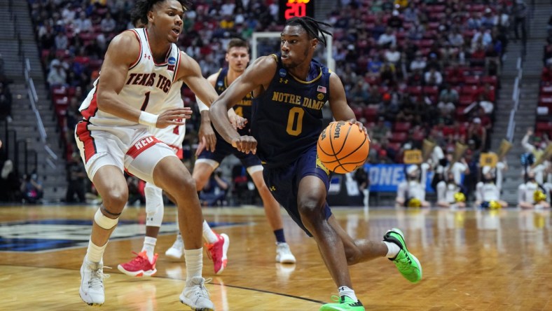 Mar 20, 2022; San Diego, CA, USA; Notre Dame Fighting Irish guard Blake Wesley (0) drives against Texas Tech Red Raiders guard Terrence Shannon Jr. (1) in the first half during the second round of the 2022 NCAA Tournament at Viejas Arena. Mandatory Credit: Kirby Lee-USA TODAY Sports