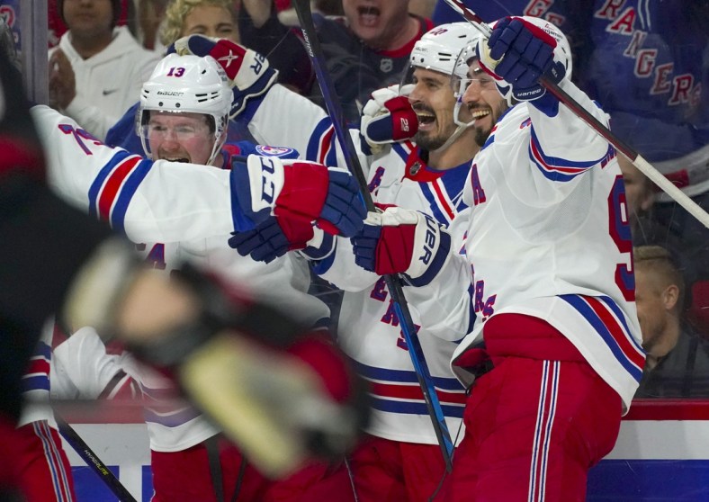 Mar 20, 2022; Raleigh, North Carolina, USA;  New York Rangers left wing Chris Kreider (20) is congratulated by  center Mika Zibanejad (93) and left wing Alexis Lafreni  re (13) after his goal against the Carolina Hurricanes during the second period at PNC Arena. Mandatory Credit: James Guillory-USA TODAY Sports