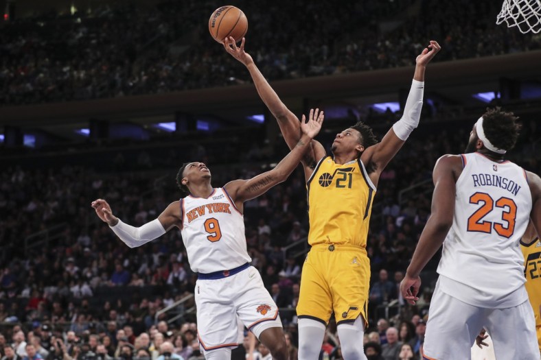 Mar 20, 2022; New York, New York, USA;  New York Knicks guard RJ Barrett (9) and Utah Jazz center Hassan Whiteside (21) fights for a loose ball in the second quarter at Madison Square Garden. Mandatory Credit: Wendell Cruz-USA TODAY Sports