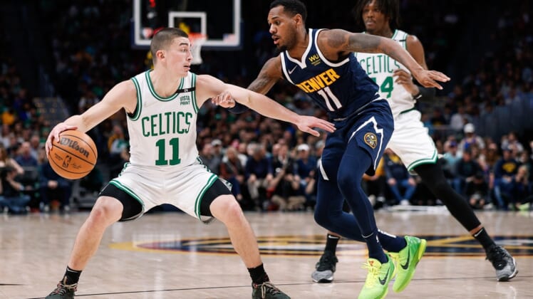 Mar 20, 2022; Denver, Colorado, USA; Boston Celtics guard Payton Pritchard (11) controls the ball under pressure from Denver Nuggets guard Monte Morris (11) in the second quarter at Ball Arena. Mandatory Credit: Isaiah J. Downing-USA TODAY Sports