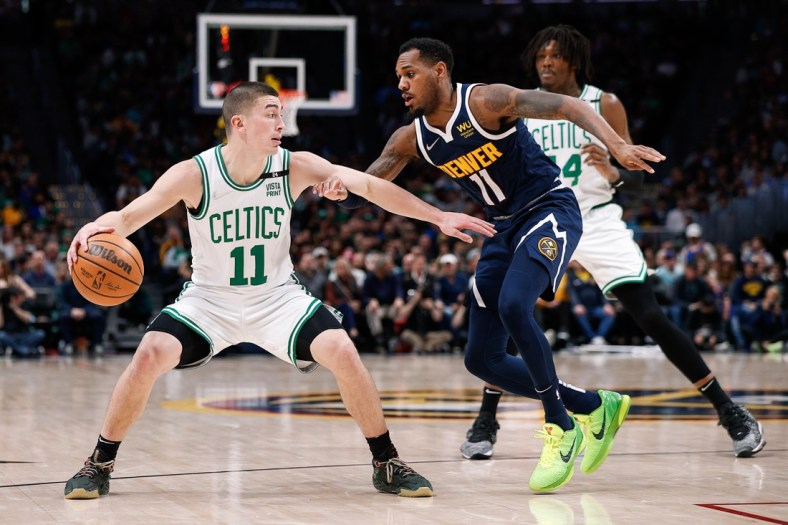 Mar 20, 2022; Denver, Colorado, USA; Boston Celtics guard Payton Pritchard (11) controls the ball under pressure from Denver Nuggets guard Monte Morris (11) in the second quarter at Ball Arena. Mandatory Credit: Isaiah J. Downing-USA TODAY Sports