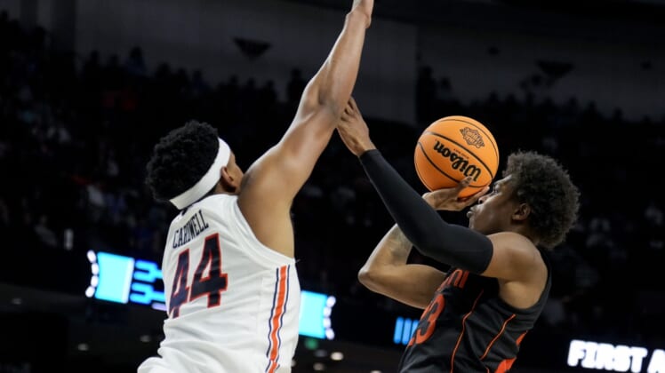 Mar 20, 2022; Greenville, SC, USA; Auburn Tigers center Dylan Cardwell (44) defends against Miami (Fl) Hurricanes guard Kameron McGusty (23) in the second half during the second round of the 2022 NCAA Tournament at Bon Secours Wellness Arena. Mandatory Credit: Jim Dedmon-USA TODAY Sports