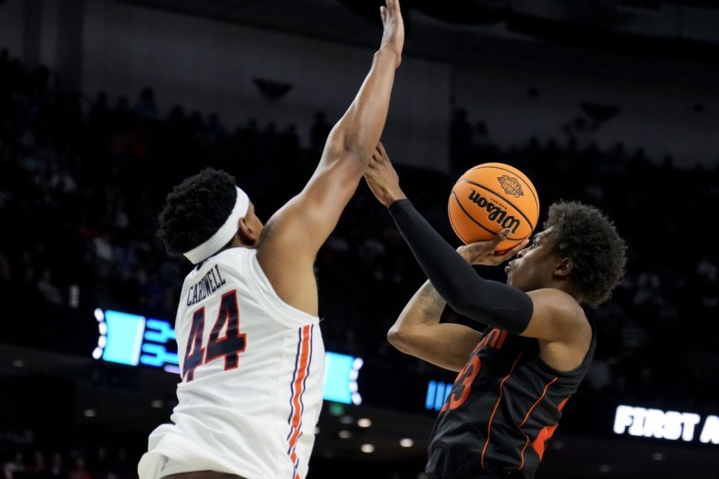 Mar 20, 2022; Greenville, SC, USA; Auburn Tigers center Dylan Cardwell (44) defends against Miami (Fl) Hurricanes guard Kameron McGusty (23) in the second half during the second round of the 2022 NCAA Tournament at Bon Secours Wellness Arena. Mandatory Credit: Jim Dedmon-USA TODAY Sports