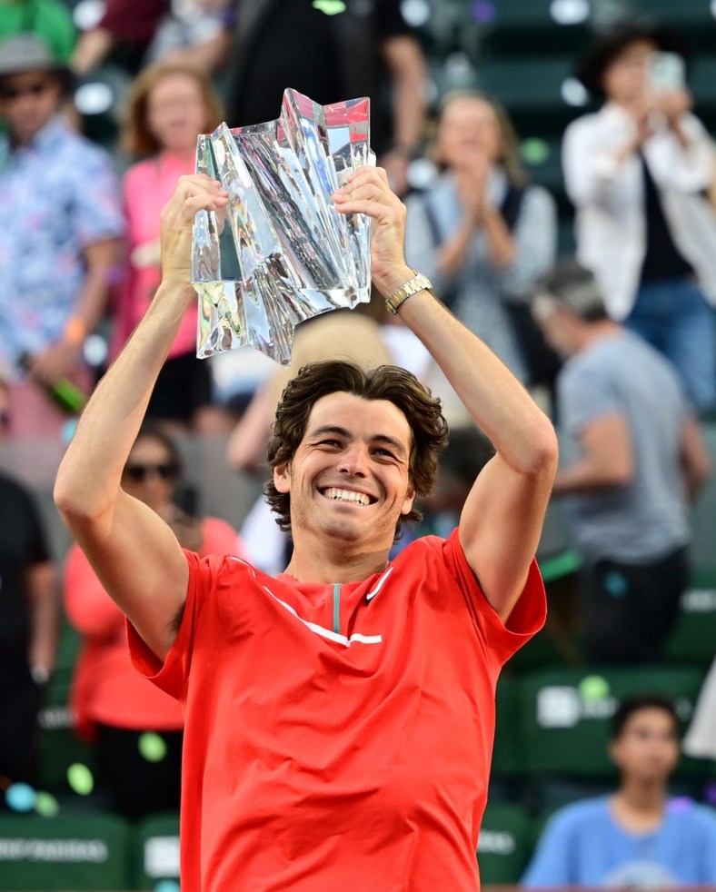 Mar 20, 2022; Indian Wells, CA, USA;   Taylor Fritz (USA) holds the championship trophy after defeating Rafael Nadal (ESP) in the men   s final at the BNP Paribas Open at the Indian Wells Tennis Garden. Mandatory Credit: Jayne Kamin-Oncea-USA TODAY Sports