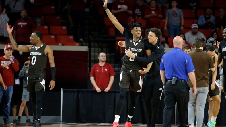 St. Bonaventure's Osun Osunniyi (21) and Kyle Lofton (0) celebrate after a men's college basketball game between the University of Oklahoma Sooners (OU) and St. Bonaventure at Lloyd Noble Center in Norman, Okla., Sunday, March 20, 2022. St. Bonaventure won 70-68.

Ou Nit