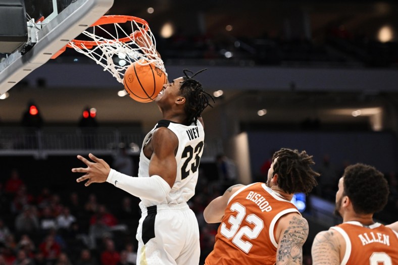 Mar 20, 2022; Milwaukee, WI, USA; Purdue Boilermakers guard Jaden Ivey (23) dunks the ball against Texas Longhorns forward Christian Bishop (32) during the second half in the second round of the 2022 NCAA Tournament at Fiserv Forum. Mandatory Credit: Benny Sieu-USA TODAY Sports