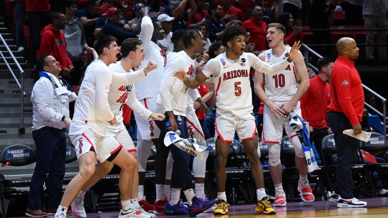 Mar 20, 2022; San Diego, CA, USA; Arizona Wildcats guard Justin Kier (5) and forward Azuolas Tubelis (10) react with the bench after a dunk by a teammate in the second half against the TCU Horned Frogs during the second round of the 2022 NCAA Tournament at Viejas Arena. Mandatory Credit: Orlando Ramirez-USA TODAY Sports