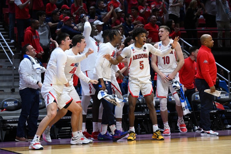 Mar 20, 2022; San Diego, CA, USA; Arizona Wildcats guard Justin Kier (5) and forward Azuolas Tubelis (10) react with the bench after a dunk by a teammate in the second half against the TCU Horned Frogs during the second round of the 2022 NCAA Tournament at Viejas Arena. Mandatory Credit: Orlando Ramirez-USA TODAY Sports
