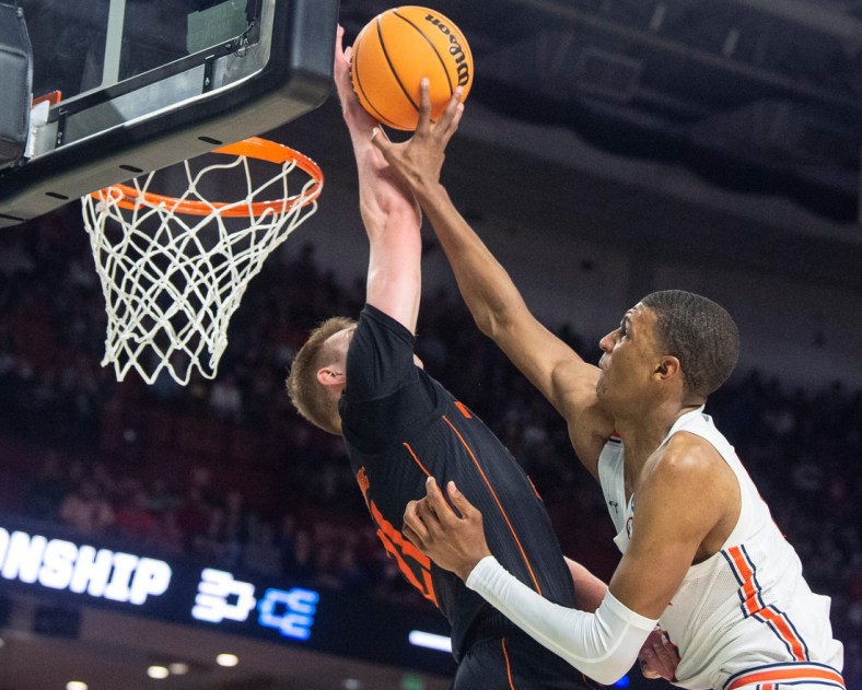 Miami Hurricanes forward Sam Waardenburg (21) blocks Auburn Tigers forward Jabari Smith (10) dunk attempt during the second round of the 2022 NCAA tournament at Bon Secours Wellness Arena in Greenville, S.C., on Sunday, March 20, 2022. Miami Hurricanes defeated Auburn Tigers 79-61.