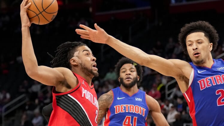 Mar 21, 2022; Detroit, Michigan, USA; Portland Trail Blazers forward Trendon Watford (2) goes up for a shot against Detroit Pistons guard Cade Cunningham (2) during the first quarter at Little Caesars Arena. Mandatory Credit: Raj Mehta-USA TODAY Sports