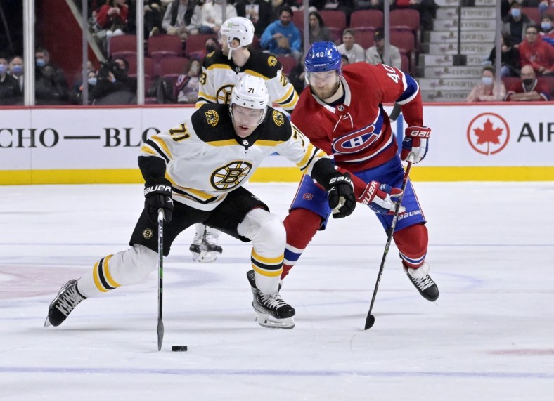 Mar 21, 2022; Montreal, Quebec, CAN; Boston Bruins forward Taylor Hall (71) plays the puck as Montreal Canadiens forward Joel Armia (40) defends during the first period at the Bell Centre. Mandatory Credit: Eric Bolte-USA TODAY Sports