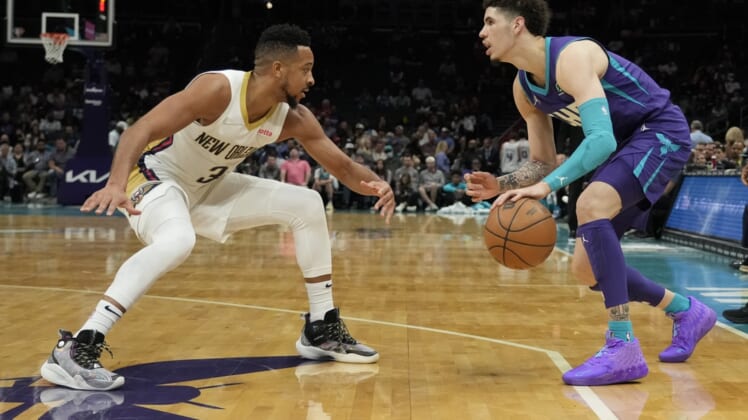 Mar 21, 2022; Charlotte, North Carolina, USA; Charlotte Hornets guard LaMelo Ball (2) dribbles the ball against New Orleans Pelicans guard CJ McCollum (3) during the second quarter at Spectrum Center. Mandatory Credit: Jim Dedmon-USA TODAY Sports