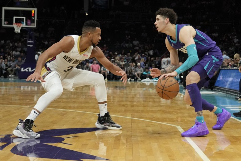 Mar 21, 2022; Charlotte, North Carolina, USA; Charlotte Hornets guard LaMelo Ball (2) dribbles the ball against New Orleans Pelicans guard CJ McCollum (3) during the second quarter at Spectrum Center. Mandatory Credit: Jim Dedmon-USA TODAY Sports