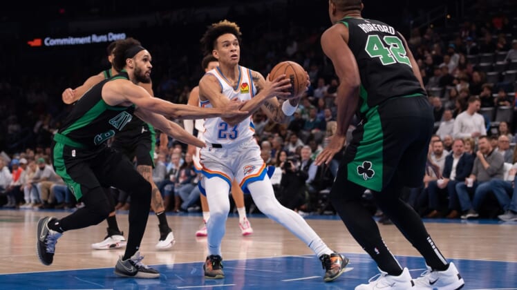 Mar 21, 2022; Oklahoma City, Oklahoma, USA; Oklahoma City Thunder guard Tre Mann (23) moves the ball while defended by Boston Celtics guard Derrick White (9) and  center Al Horford (42) during the first half at Paycom Center. Mandatory Credit: Rob Ferguson-USA TODAY Sports