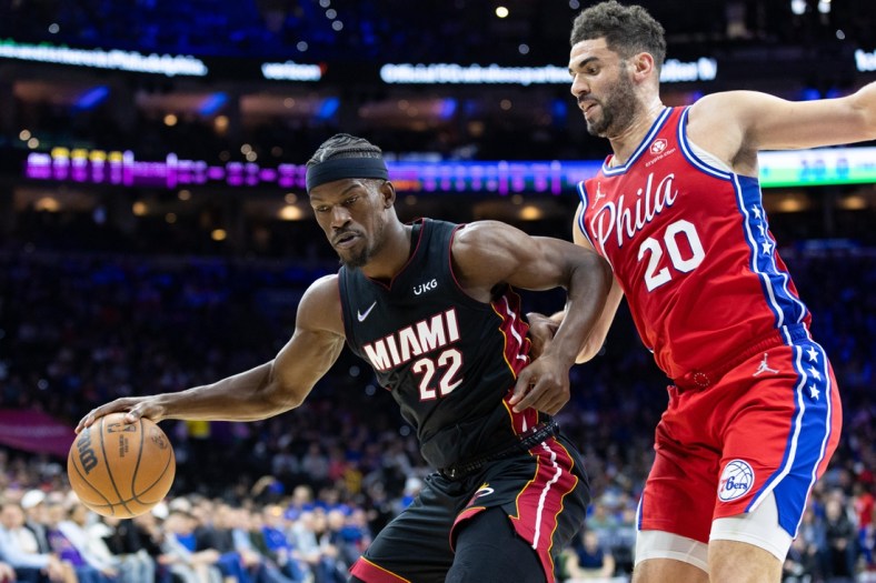Mar 21, 2022; Philadelphia, Pennsylvania, USA; Miami Heat forward Jimmy Butler (22) dribbles the ball against Philadelphia 76ers forward Georges Niang (20) during the second quarter at Wells Fargo Center. Mandatory Credit: Bill Streicher-USA TODAY Sports