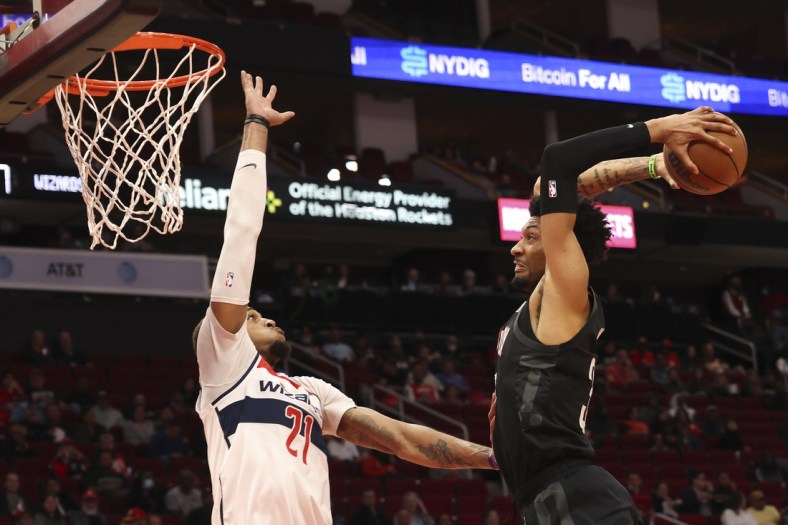 Mar 21, 2022; Houston, Texas, USA; Houston Rockets center Christian Wood (35) is fouled as he goes to the basket by Washington Wizards center Daniel Gafford (21) in the second quarter at Toyota Center. Mandatory Credit: Thomas Shea-USA TODAY Sports