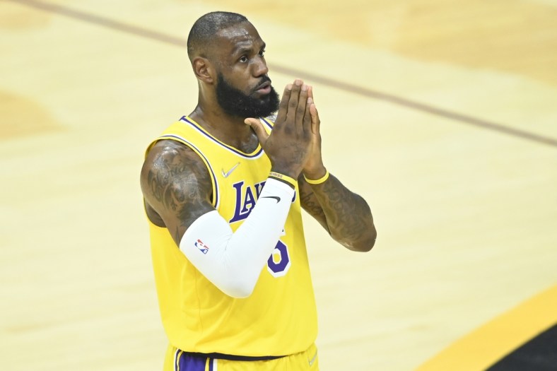 Mar 21, 2022; Cleveland, Ohio, USA; Los Angeles Lakers forward LeBron James (6) reacts to cheers in the first quarter against the Cleveland Cavaliers at Rocket Mortgage FieldHouse. Mandatory Credit: David Richard-USA TODAY Sports