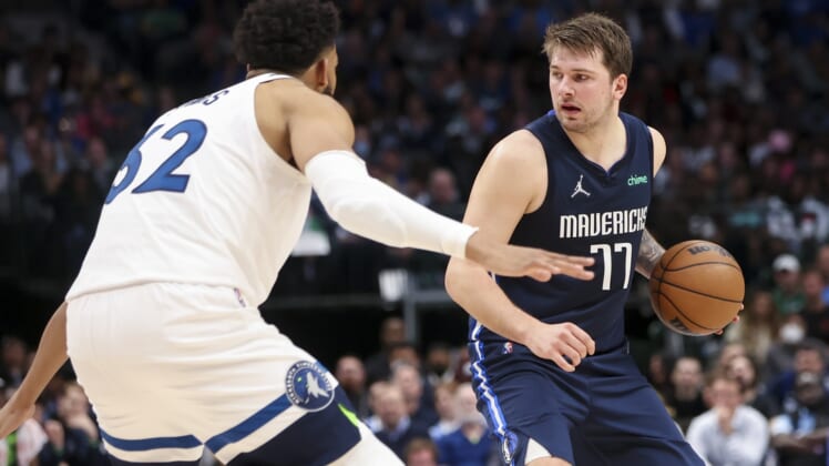 Mar 21, 2022; Dallas, Texas, USA;  Dallas Mavericks guard Luka Doncic (77) looks to score as Minnesota Timberwolves center Karl-Anthony Towns (32) defends during the second quarter at American Airlines Center. Mandatory Credit: Kevin Jairaj-USA TODAY Sports