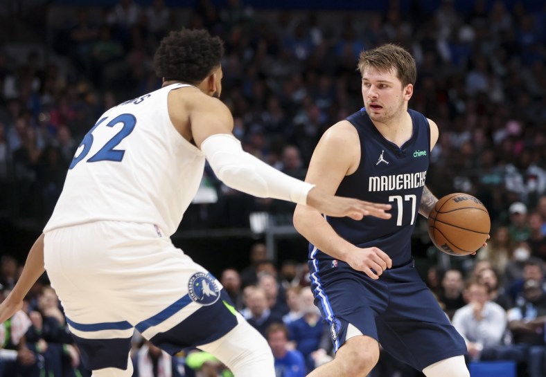 Mar 21, 2022; Dallas, Texas, USA;  Dallas Mavericks guard Luka Doncic (77) looks to score as Minnesota Timberwolves center Karl-Anthony Towns (32) defends during the second quarter at American Airlines Center. Mandatory Credit: Kevin Jairaj-USA TODAY Sports