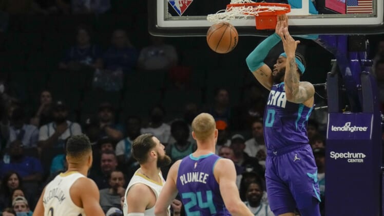 Mar 21, 2022; Charlotte, North Carolina, USA; Charlotte Hornets forward Miles Bridges (0) dunks the ball against the New Orleans Pelicans during the second half at Spectrum Center. Mandatory Credit: Jim Dedmon-USA TODAY Sports