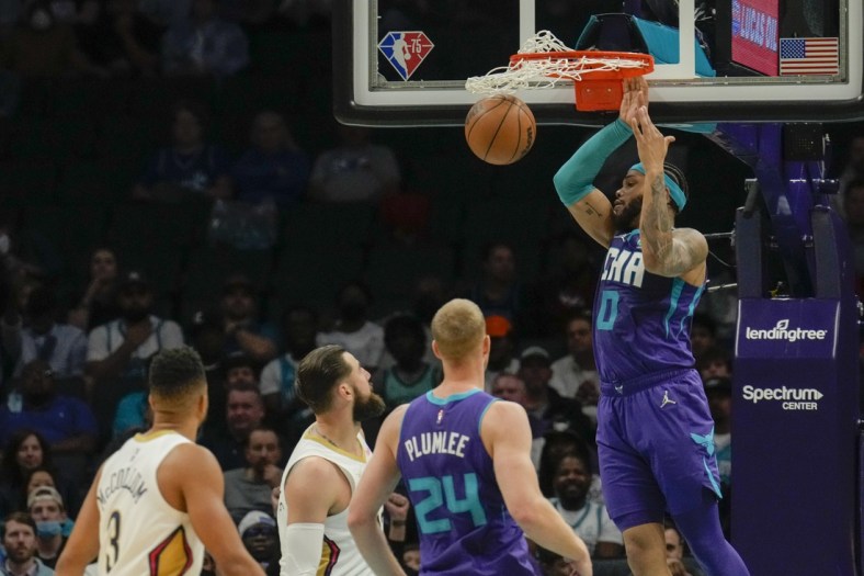 Mar 21, 2022; Charlotte, North Carolina, USA; Charlotte Hornets forward Miles Bridges (0) dunks the ball against the New Orleans Pelicans during the second half at Spectrum Center. Mandatory Credit: Jim Dedmon-USA TODAY Sports