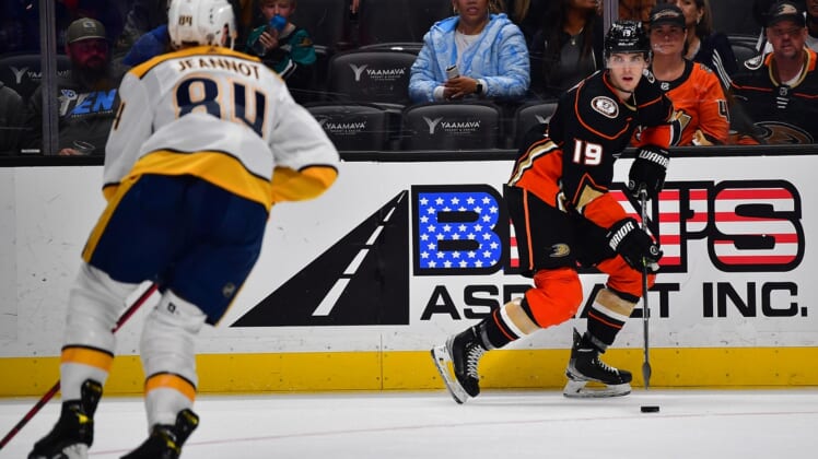 Mar 21, 2022; Anaheim, California, USA; Anaheim Ducks right wing Troy Terry (19) moves the puck against Nashville Predators left wing Tanner Jeannot (84) during the second period at Honda Center. Mandatory Credit: Gary A. Vasquez-USA TODAY Sports