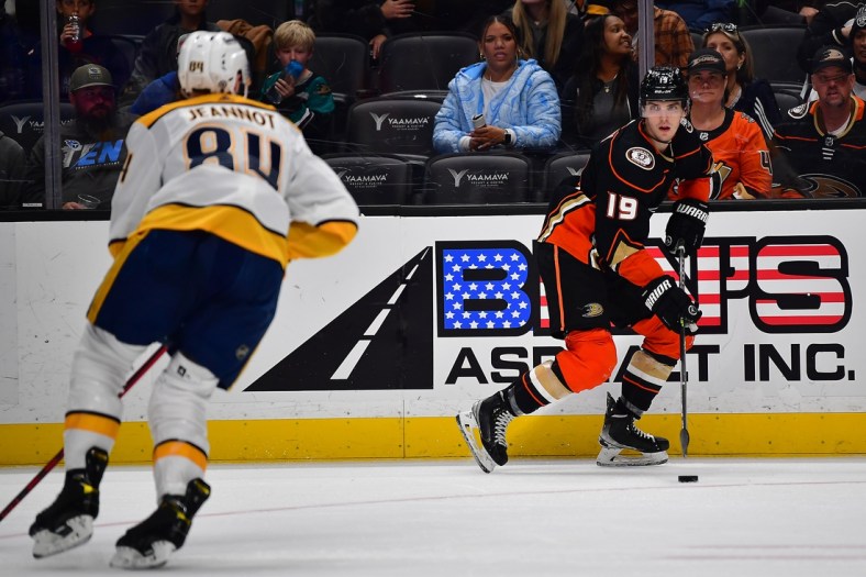 Mar 21, 2022; Anaheim, California, USA; Anaheim Ducks right wing Troy Terry (19) moves the puck against Nashville Predators left wing Tanner Jeannot (84) during the second period at Honda Center. Mandatory Credit: Gary A. Vasquez-USA TODAY Sports