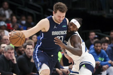 Mar 21, 2022; Dallas, Texas, USA;  Dallas Mavericks guard Luka Doncic (77) controls the ball as Minnesota Timberwolves guard Patrick Beverley (22) defends during the second half at American Airlines Center. Mandatory Credit: Kevin Jairaj-USA TODAY Sports