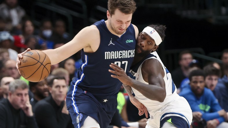 Mar 21, 2022; Dallas, Texas, USA;  Dallas Mavericks guard Luka Doncic (77) controls the ball as Minnesota Timberwolves guard Patrick Beverley (22) defends during the second half at American Airlines Center. Mandatory Credit: Kevin Jairaj-USA TODAY Sports