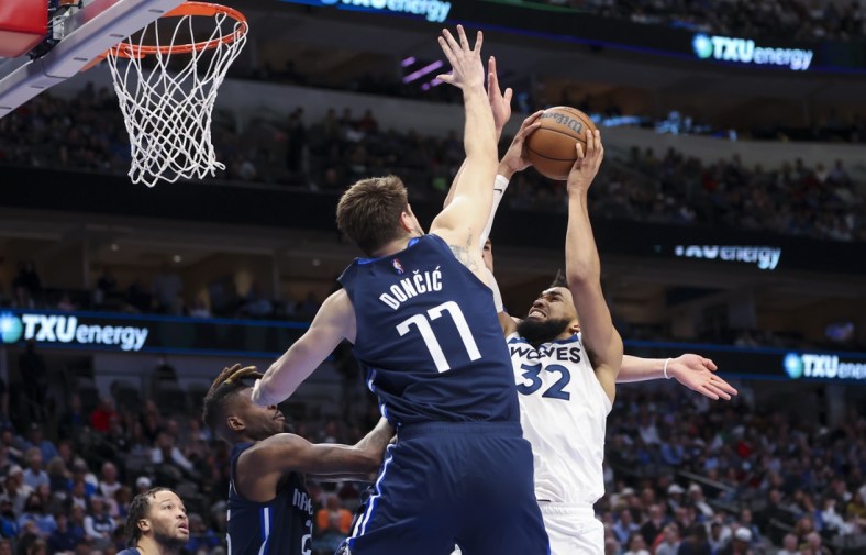 Mar 21, 2022; Dallas, Texas, USA;  Minnesota Timberwolves center Karl-Anthony Towns (32) shoots over Dallas Mavericks guard Luka Doncic (77) during the second half at American Airlines Center. Mandatory Credit: Kevin Jairaj-USA TODAY Sports