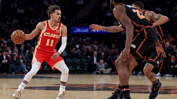 Mar 22, 2022; New York, New York, USA; Atlanta Hawks guard Trae Young (11) dribbles against New York Knicks center Mitchell Robinson (23) and forward Obi Toppin (1) during the first quarter at Madison Square Garden. Mandatory Credit: Vincent Carchietta-USA TODAY Sports