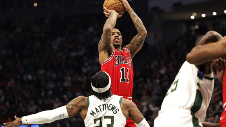 Mar 22, 2022; Milwaukee, Wisconsin, USA;  Chicago Bulls guard DeMar DeRozan (11) shoots over Milwaukee Bucks guard Wesley Matthews (23) during the second quarter at Fiserv Forum. Mandatory Credit: Jeff Hanisch-USA TODAY Sports