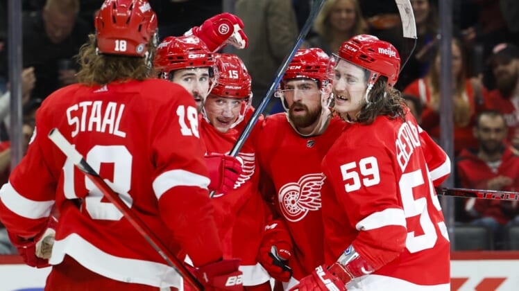 Mar 22, 2022; Detroit, Michigan, USA;  Detroit Red Wings left wing Jakub Vrana (15) receives congratulations from teammates after scoring in the second period against the Philadelphia Flyers at Little Caesars Arena. Mandatory Credit: Rick Osentoski-USA TODAY Sports