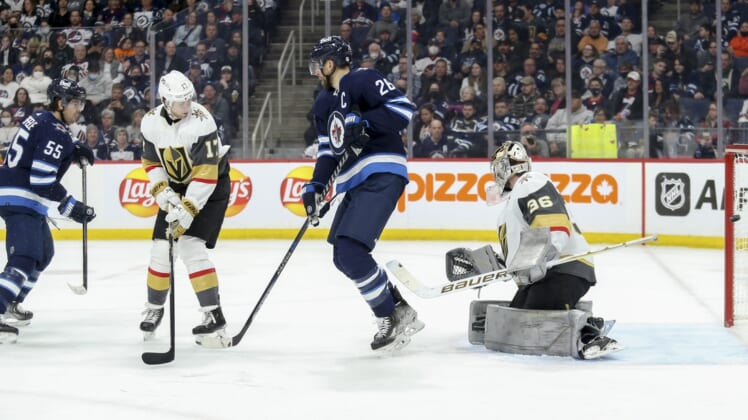 Mar 22, 2022; Winnipeg, Manitoba, CAN;  Winnipeg Jets forward Mark Scheifele (55) scores against Vegas Golden Knights goalie Logan Thompson (36) during the second period at Canada Life Centre. Mandatory Credit: Terrence Lee-USA TODAY Sports