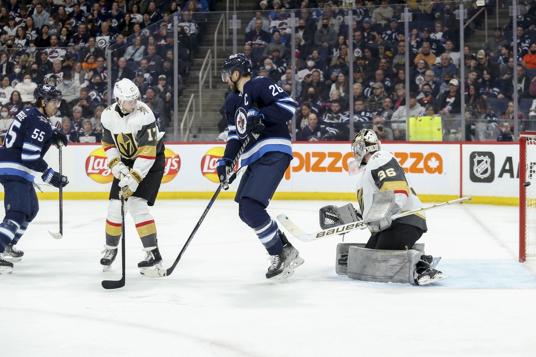 Mar 22, 2022; Winnipeg, Manitoba, CAN;  Winnipeg Jets forward Mark Scheifele (55) scores against Vegas Golden Knights goalie Logan Thompson (36) during the second period at Canada Life Centre. Mandatory Credit: Terrence Lee-USA TODAY Sports