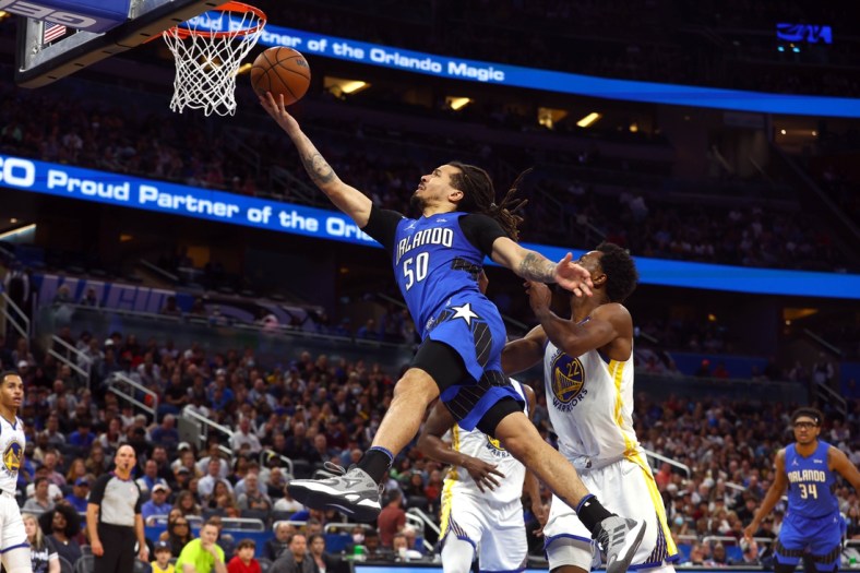 Mar 22, 2022; Orlando, Florida, USA; Orlando Magic guard Cole Anthony (50) makes a layup against the Golden State Warriors during the second half at Amway Center. Mandatory Credit: Kim Klement-USA TODAY Sports