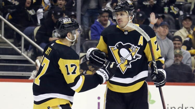 Mar 22, 2022; Pittsburgh, Pennsylvania, USA;  Pittsburgh Penguins right wing Bryan Rust (17) congratulates center Evgeni Malkin (71) on his goal against the Columbus Blue Jackets during the third period at PPG Paints Arena. The Penguins won 5-1. Mandatory Credit: Charles LeClaire-USA TODAY Sports