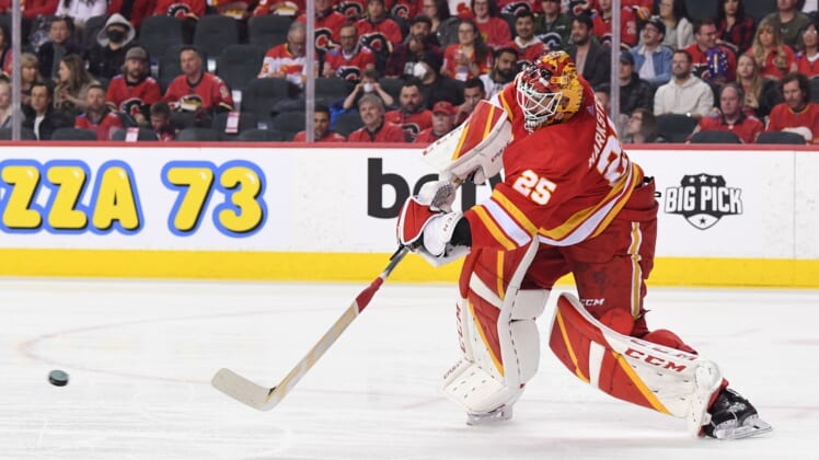 Mar 22, 2022; Calgary, Alberta, CAN; Calgary Flames goalie Jacob Markstrom (25) clears the puck against the San Jose Sharks in the second period at Scotiabank Saddledome. Mandatory Credit: Candice Ward-USA TODAY Sports