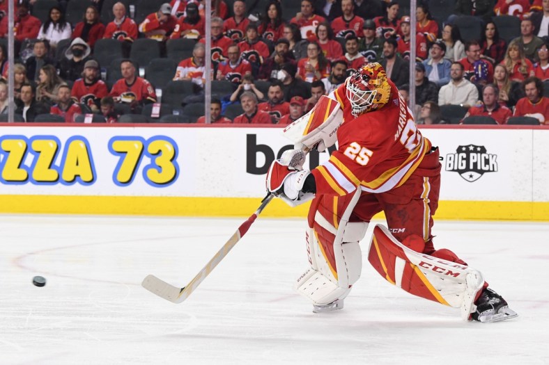 Mar 22, 2022; Calgary, Alberta, CAN; Calgary Flames goalie Jacob Markstrom (25) clears the puck against the San Jose Sharks in the second period at Scotiabank Saddledome. Mandatory Credit: Candice Ward-USA TODAY Sports