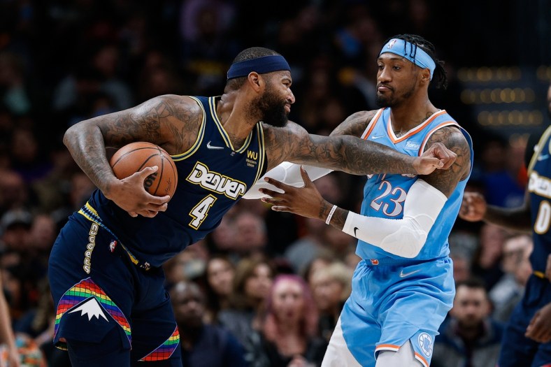 Mar 22, 2022; Denver, Colorado, USA; Denver Nuggets center DeMarcus Cousins (4) pushes Los Angeles Clippers forward Robert Covington (23) after a foul in the second quarter at Ball Arena. Mandatory Credit: Isaiah J. Downing-USA TODAY Sports