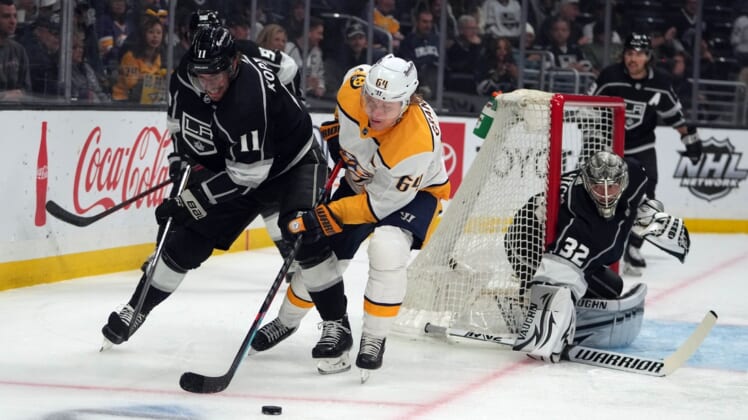 Mar 22, 2022; Los Angeles, California, USA; LA Kings center Anze Kopitar (11) and goaltender Jonathan Quick (32) defend against Nashville Predators center Mikael Granlund (64) during the first period at Crypto.com Arena. Mandatory Credit: Kirby Lee-USA TODAY Sports
