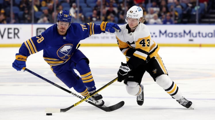 Mar 23, 2022; Buffalo, New York, USA;  Buffalo Sabres defenseman Jacob Bryson (78) and Pittsburgh Penguins left wing Danton Heinen (43) go after a loose puck during the first period at KeyBank Center. Mandatory Credit: Timothy T. Ludwig-USA TODAY Sports