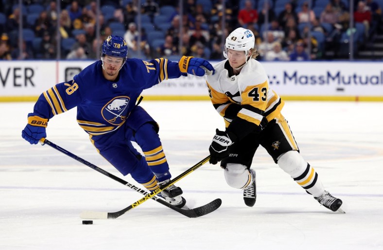 Mar 23, 2022; Buffalo, New York, USA;  Buffalo Sabres defenseman Jacob Bryson (78) and Pittsburgh Penguins left wing Danton Heinen (43) go after a loose puck during the first period at KeyBank Center. Mandatory Credit: Timothy T. Ludwig-USA TODAY Sports