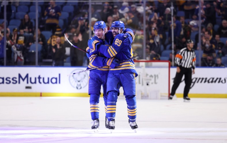Mar 23, 2022; Buffalo, New York, USA;  Buffalo Sabres right wing Alex Tuch (89) celebrates his game winning shootout goal with defenseman Rasmus Dahlin (26) against the Pittsburgh Penguins at KeyBank Center. Mandatory Credit: Timothy T. Ludwig-USA TODAY Sports