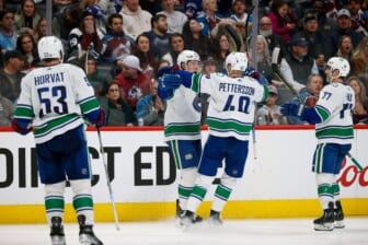 Mar 23, 2022; Denver, Colorado, USA; Vancouver Canucks right wing Brock Boeser (6) celebrates his goal with center Elias Pettersson (40) and defenseman Brad Hunt (77) and center Bo Horvat (53) in the third period against the Colorado Avalanche at Ball Arena. Mandatory Credit: Isaiah J. Downing-USA TODAY Sports