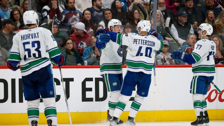 Mar 23, 2022; Denver, Colorado, USA; Vancouver Canucks right wing Brock Boeser (6) celebrates his goal with center Elias Pettersson (40) and defenseman Brad Hunt (77) and center Bo Horvat (53) in the third period against the Colorado Avalanche at Ball Arena. Mandatory Credit: Isaiah J. Downing-USA TODAY Sports