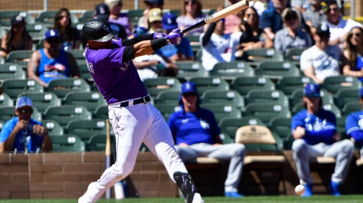 Mar 24, 2022; Salt River Pima-Maricopa, Arizona, USA;  Colorado Rockies shortstop Jose Iglesias (11) grounds out in the first inning against the Los Angeles Dodgers during spring training at Salt River Fields at Talking Stick. Mandatory Credit: Matt Kartozian-USA TODAY Sports